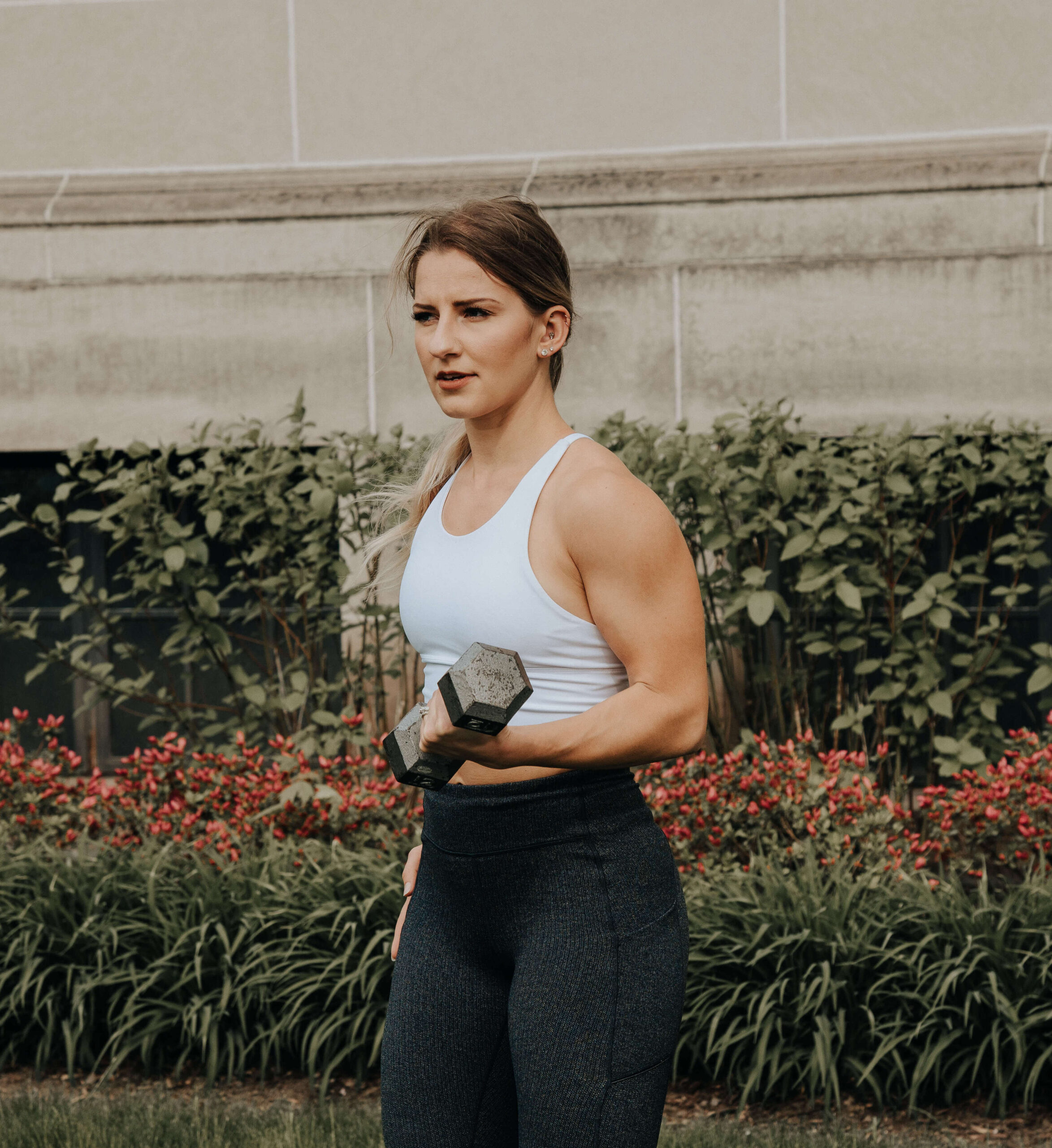 Photo of Larissa Lyons posing on a bridge in workout gear